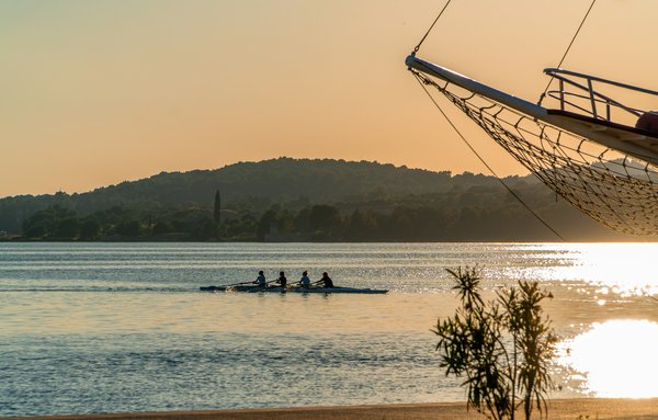 What specific Pilates exercises can help improve core strength for rowers?